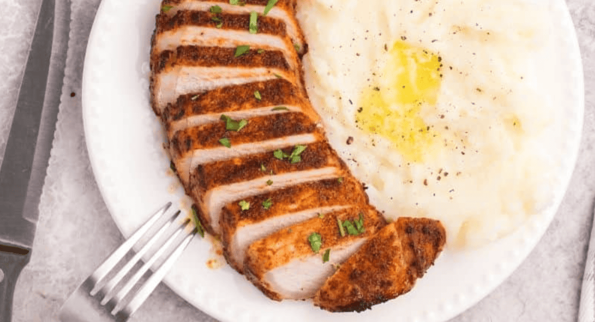 Overhead image of thick pork chops in the air fryer.