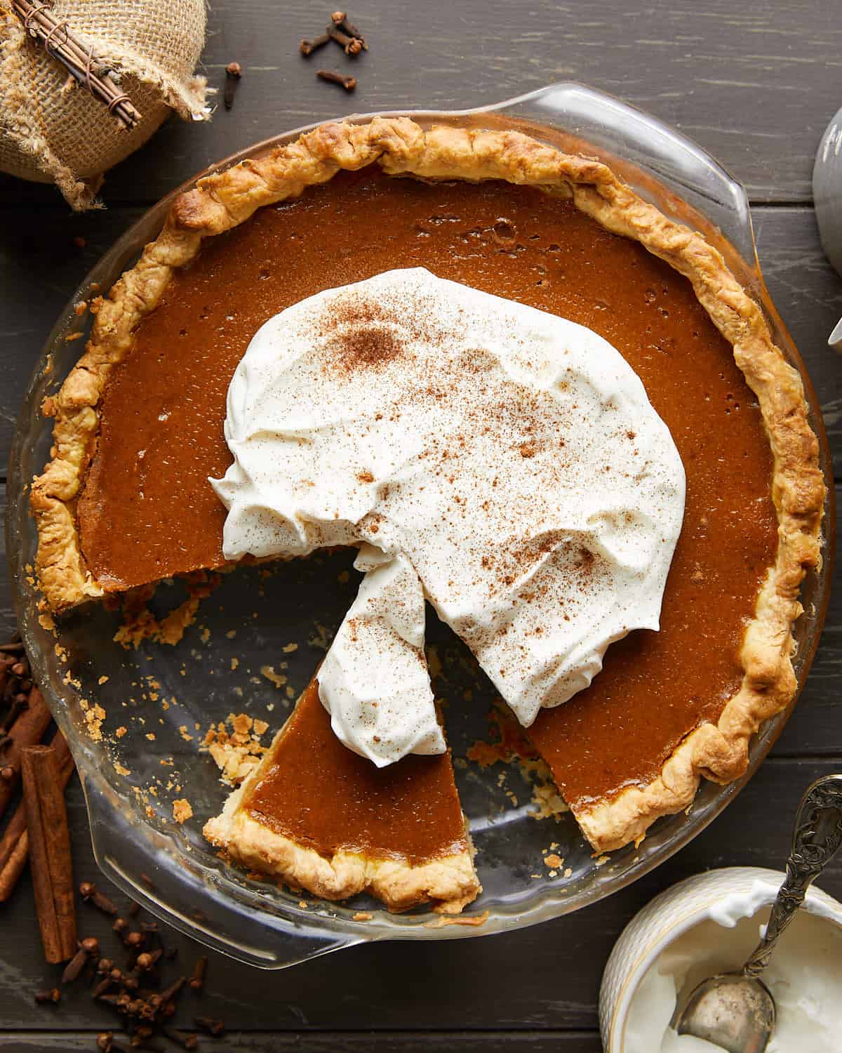 Overhead image of pumpkin pie garnished with whip cream.