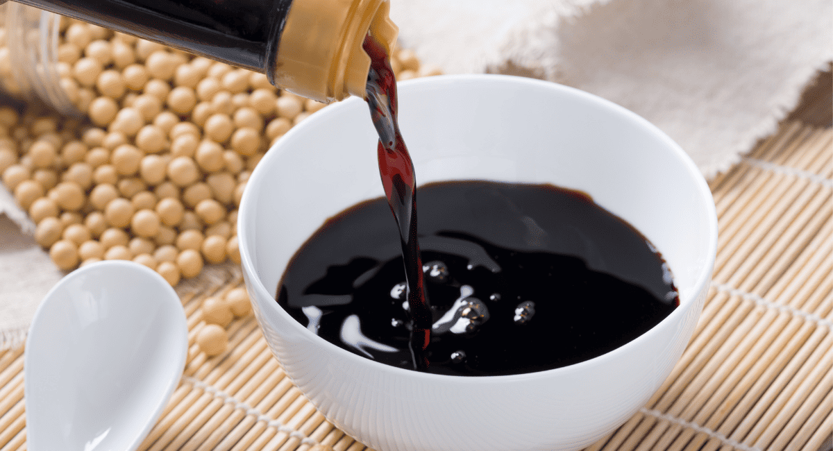 Up close image of soy sauce in white bowl.