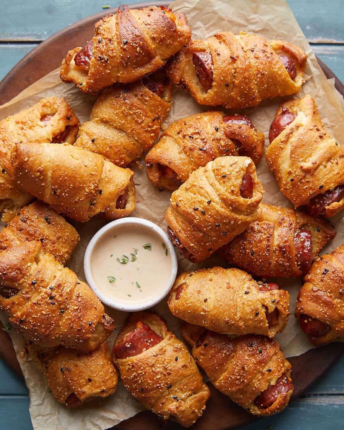 Overhead image of air fryer pigs in a blanket with garnish.