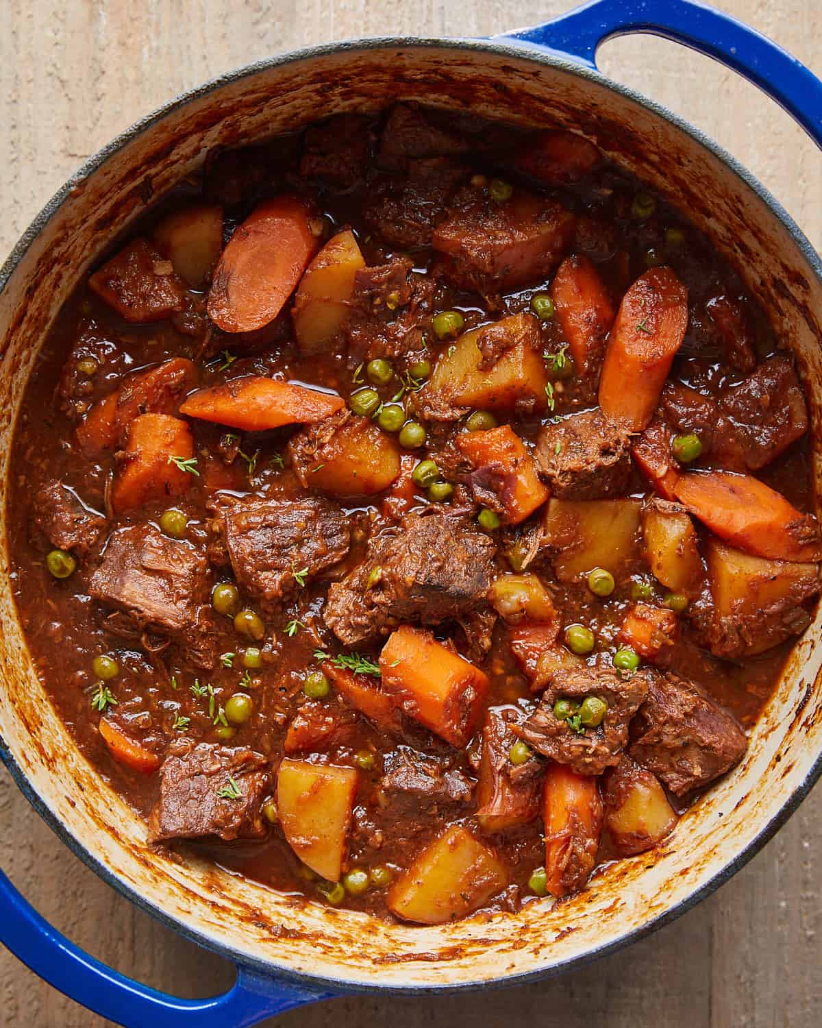 Overhead image of old fashioned beef stew in blue pot.