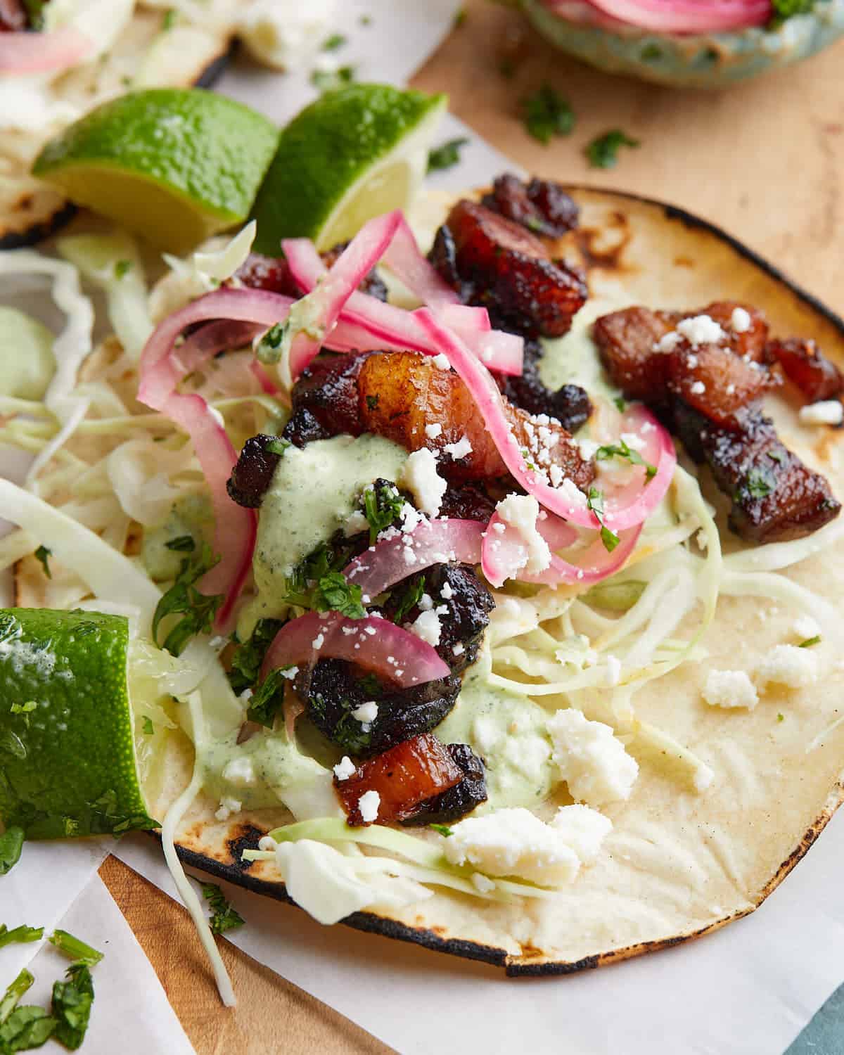 Up close image of pork belly taco with garnish.