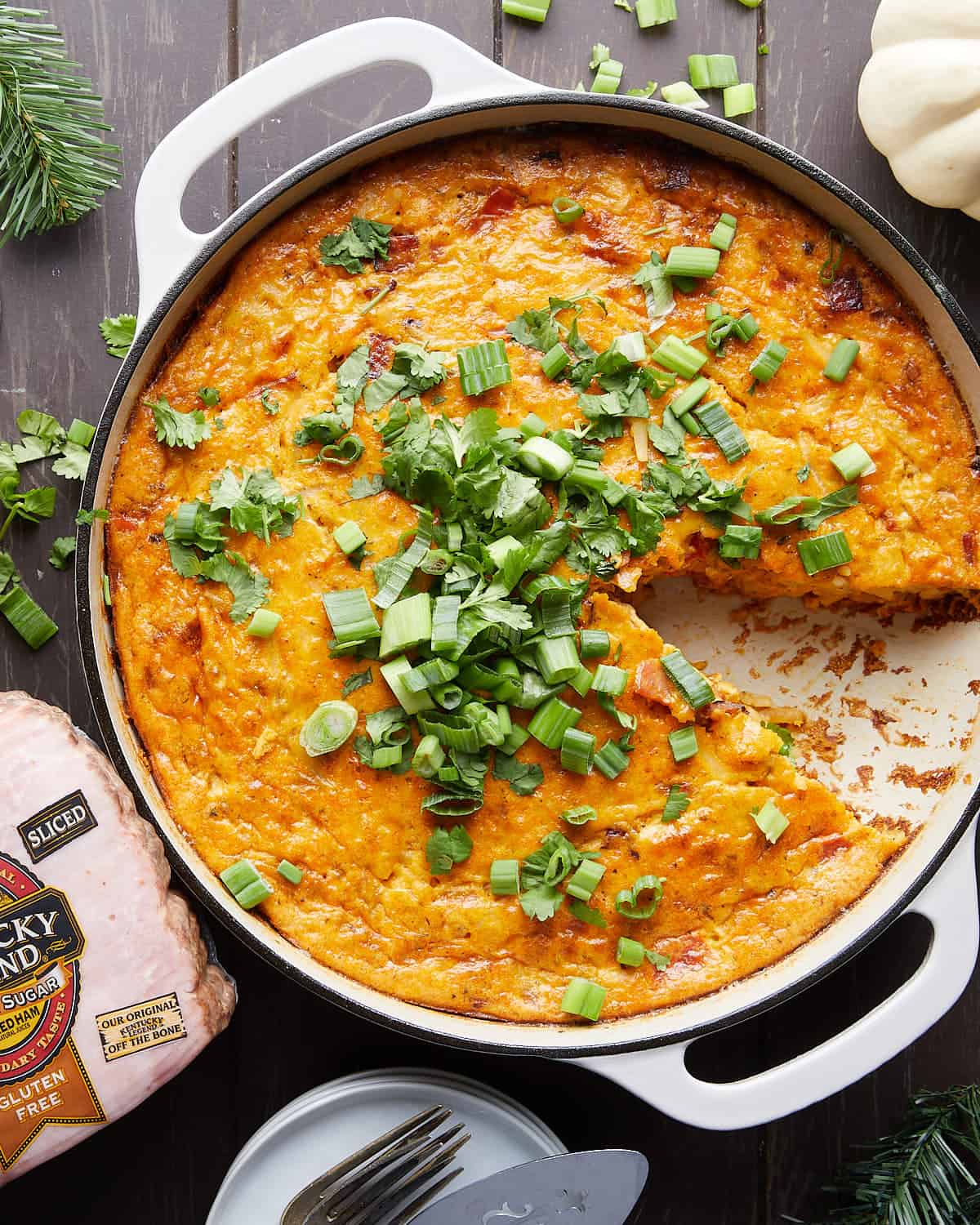 Overhead image of ham and cheese hash brown casserole with garnish. 