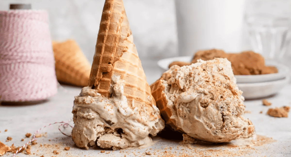 Image of snickerdoodle ice cream with waffle cone upside down. 