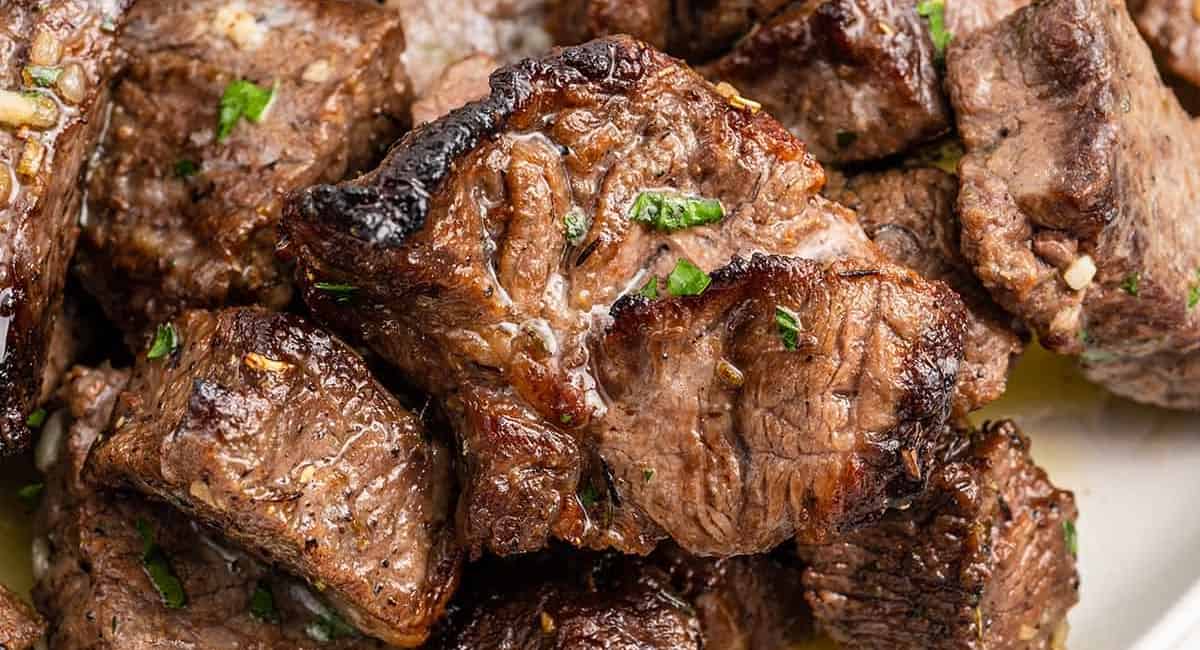 Up close image of air fryer steak bites with garnish.