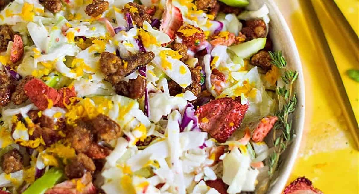 Overhead image of apple strawberry cabbage slaw with candied pecans. 