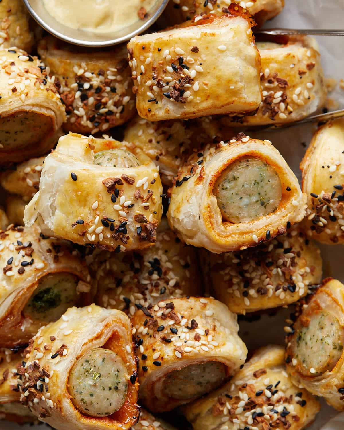 Up close image of chicken sausage rolls with puff pastry. 