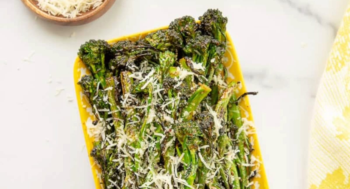 Overhead image of charred spicy broccolini with garnish. 