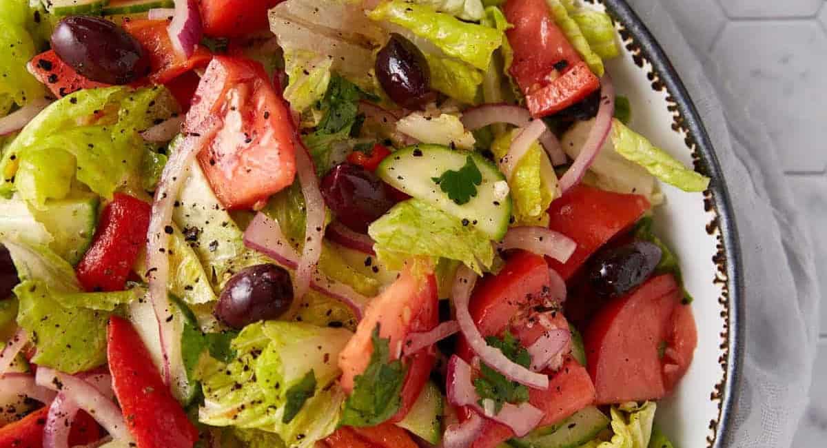 Overhead image of Greek cucumber salad with lemon dressing. 