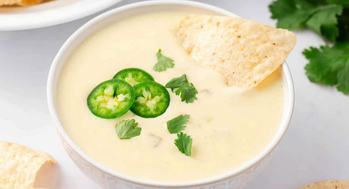Overhead image of queso blanco dip with garnish. 