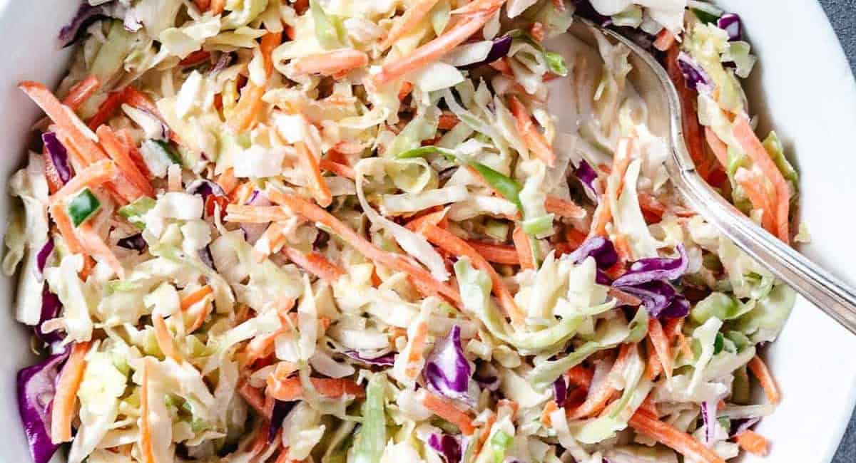 Overhead image of sweet coleslaw recipe in a white bowl. 