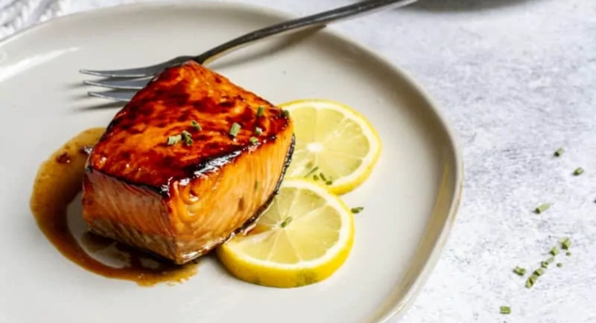 Up close image of honey bourbon salmon with garnish. 