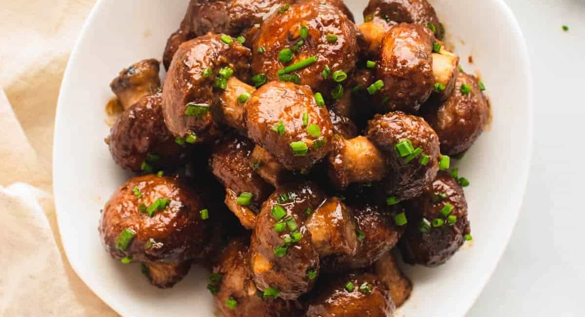 Overhead image of miso glazed mushrooms with garnish. 