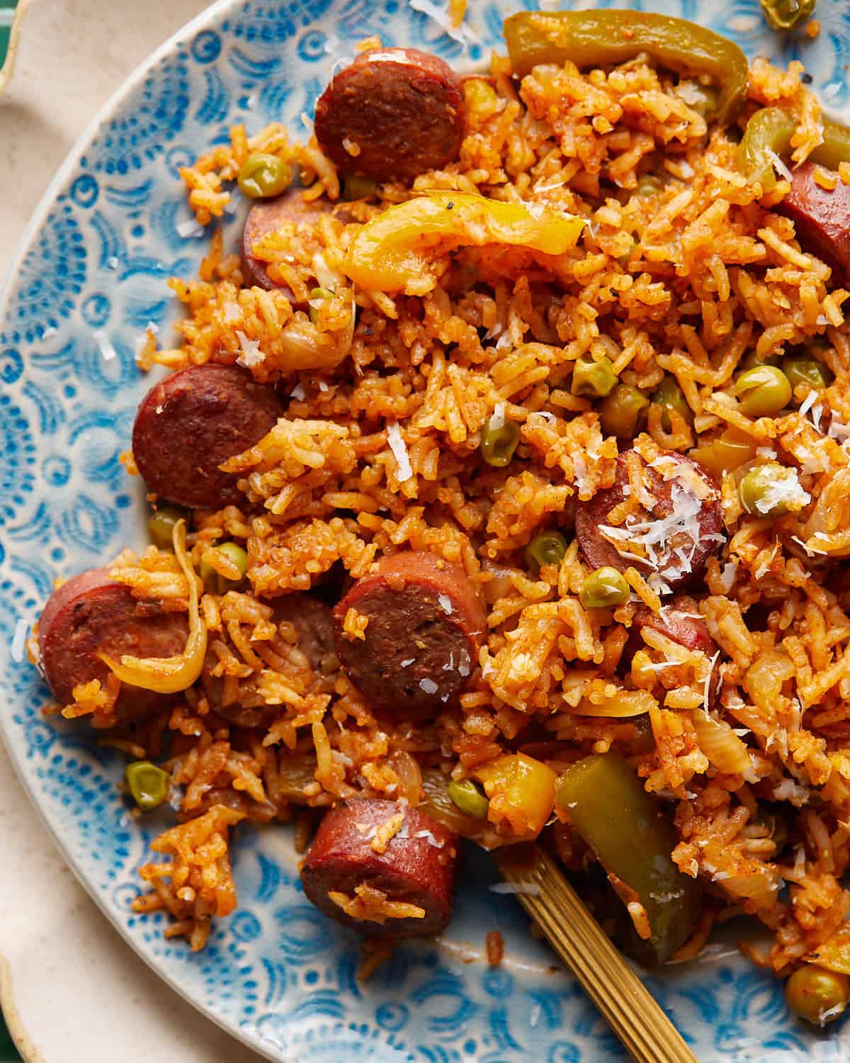 Up close image of chicken sausage and rice with parmesan topping. 