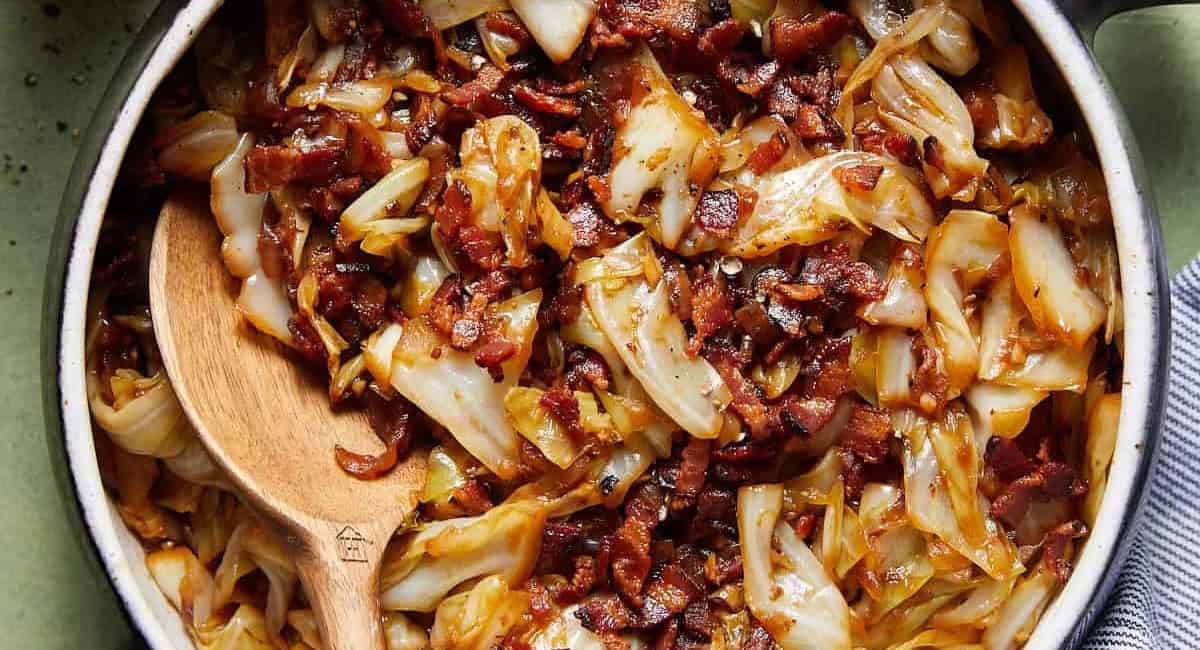 Overhead image of fried cabbage with bacon & onions. 