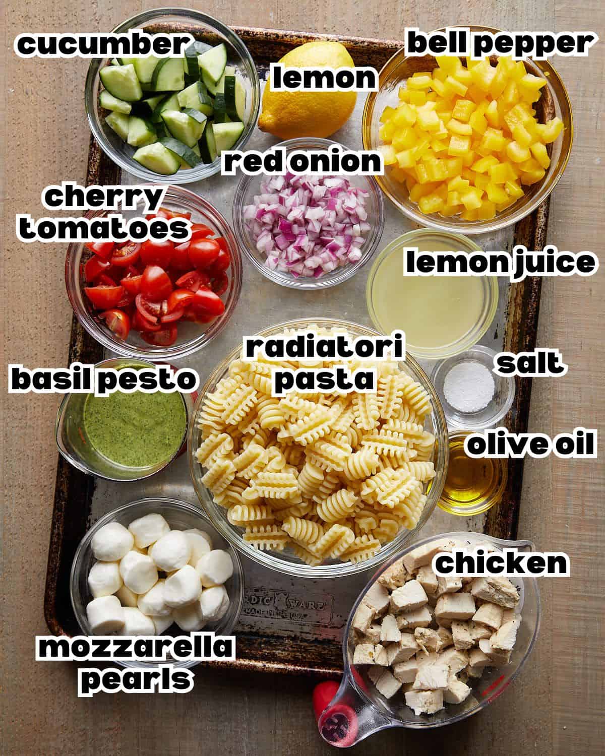 Overhead image of ingredients needed to make chicken pesto pasta salad. 