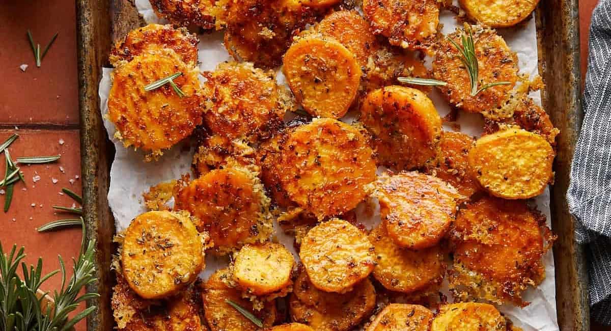 Overhead image of savory roasted sweet potatoes with parmesan and herbs. 
