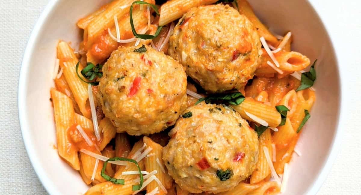 Overhead image of calabrian chicken meatballs with garnish. 