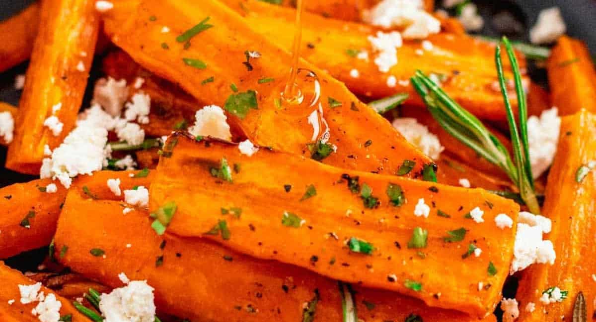 Up close image of air fryer carrots (glazed) with garnish. 