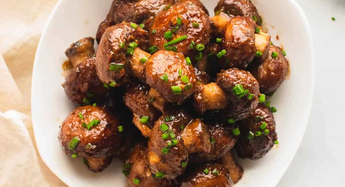 Overhead image of miso glazed mushrooms with garnish. 