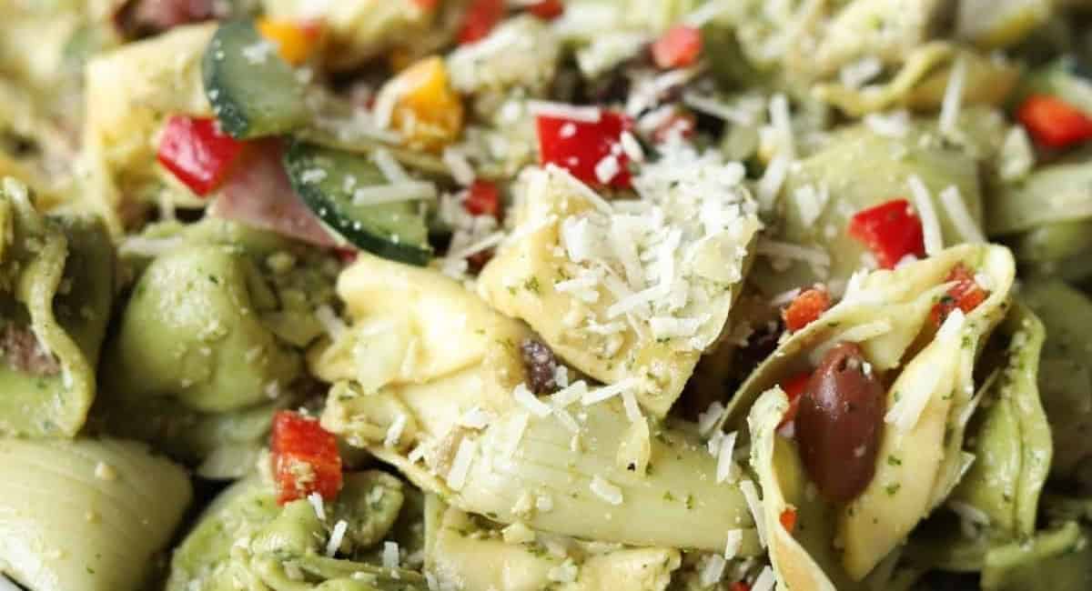 Up close image of tortellini pasta salad with pesto.
