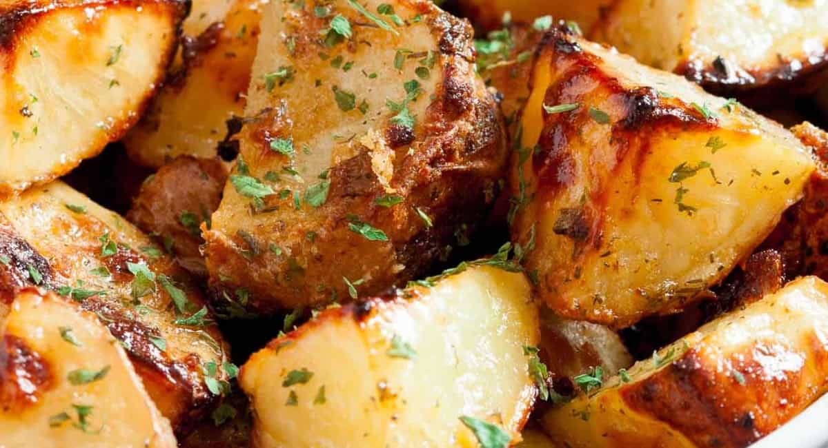 Up close image of ranch roasted potatoes with garnish. 