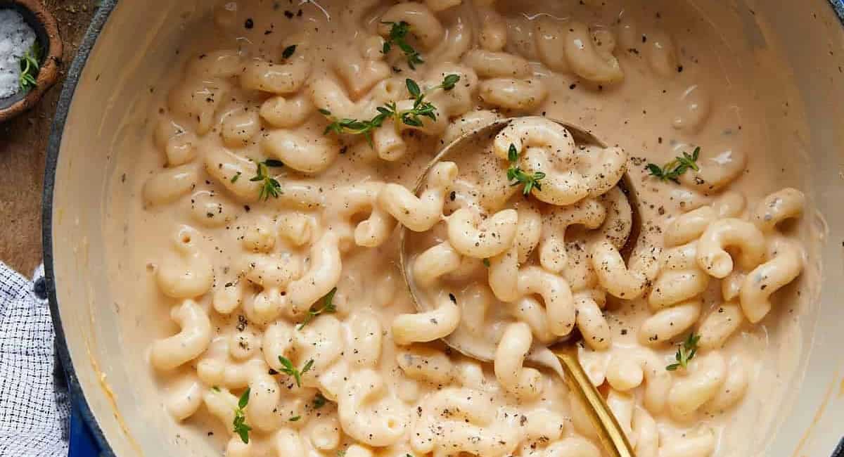 Overhead image of dutch oven mac and cheese with garnish. 