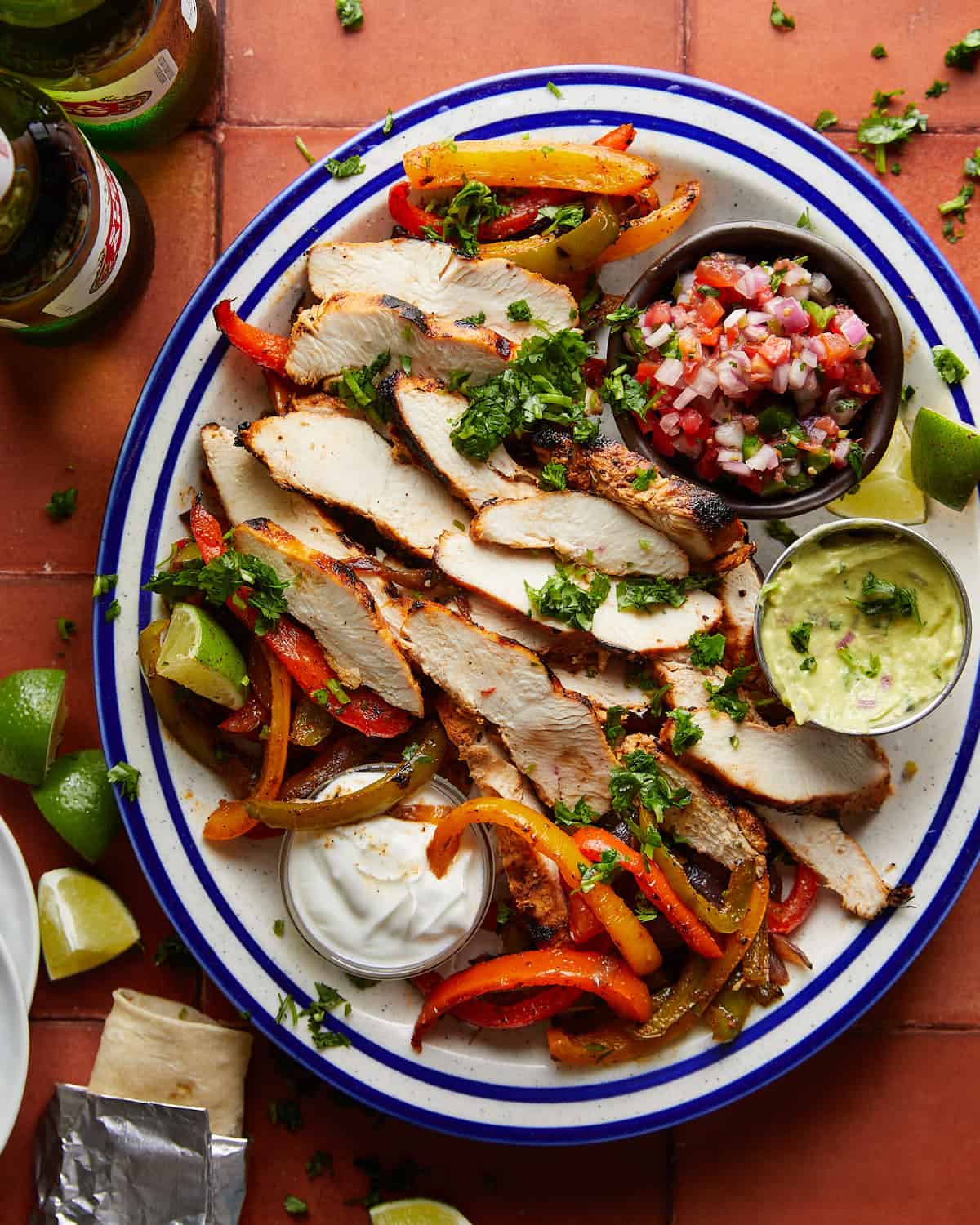 Overhead image of grilled chicken fajitas with garnish. 