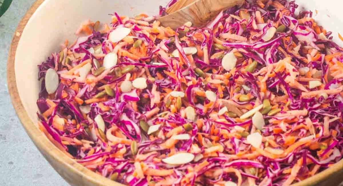 Overhead image of purple cabbage and carrot coleslaw in a bowl. 