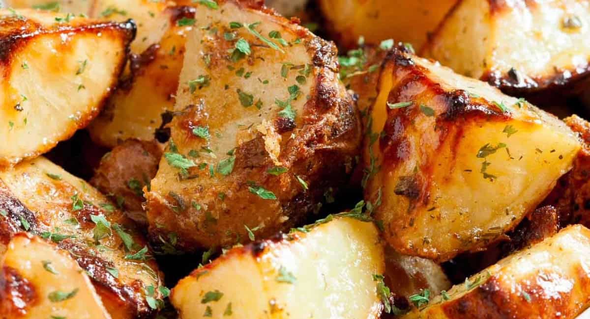 Up close image of ranch roasted potatoes with garnish. 