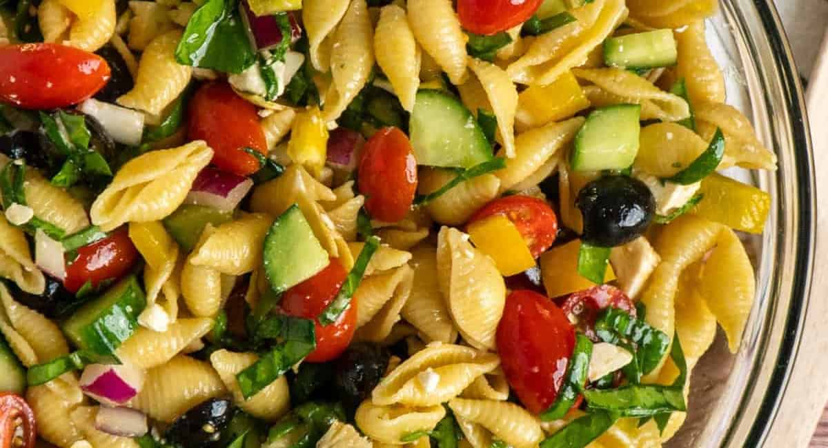 Overhead image of balsamic pasta salad in glass bowl. 