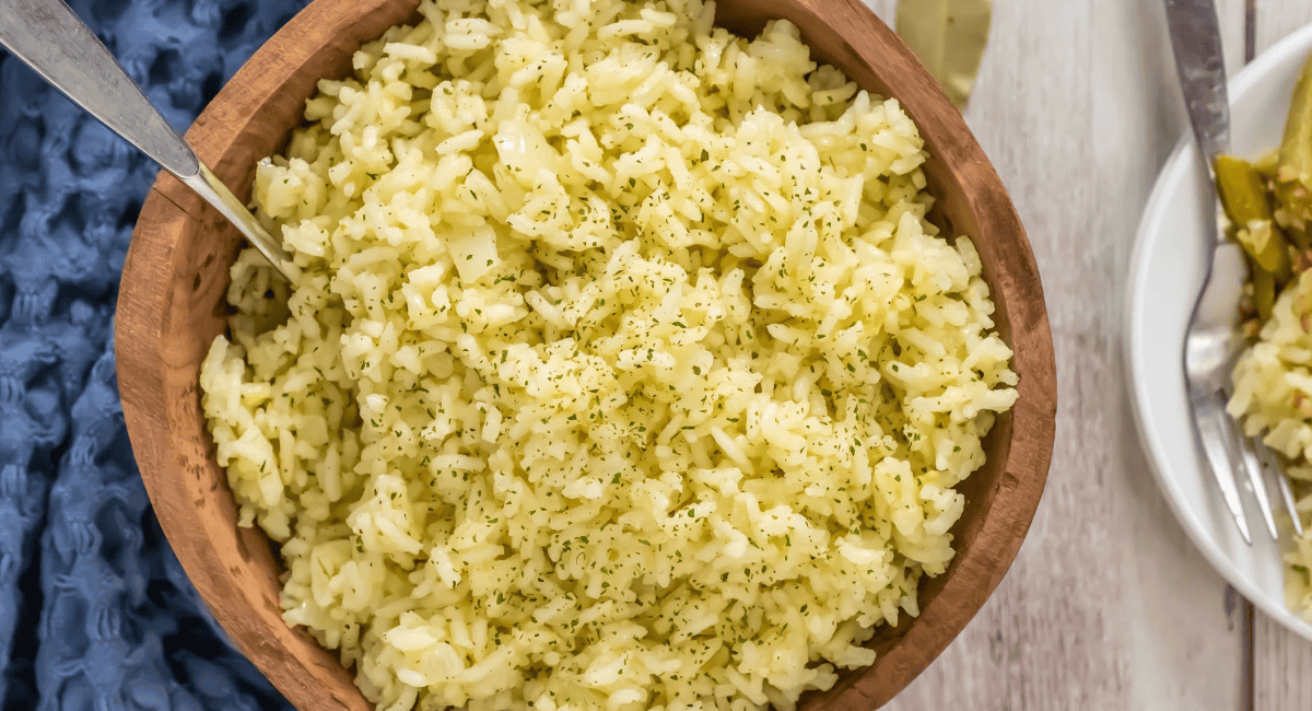 Overhead image of Butter Rice with garnish in brown bowl. 