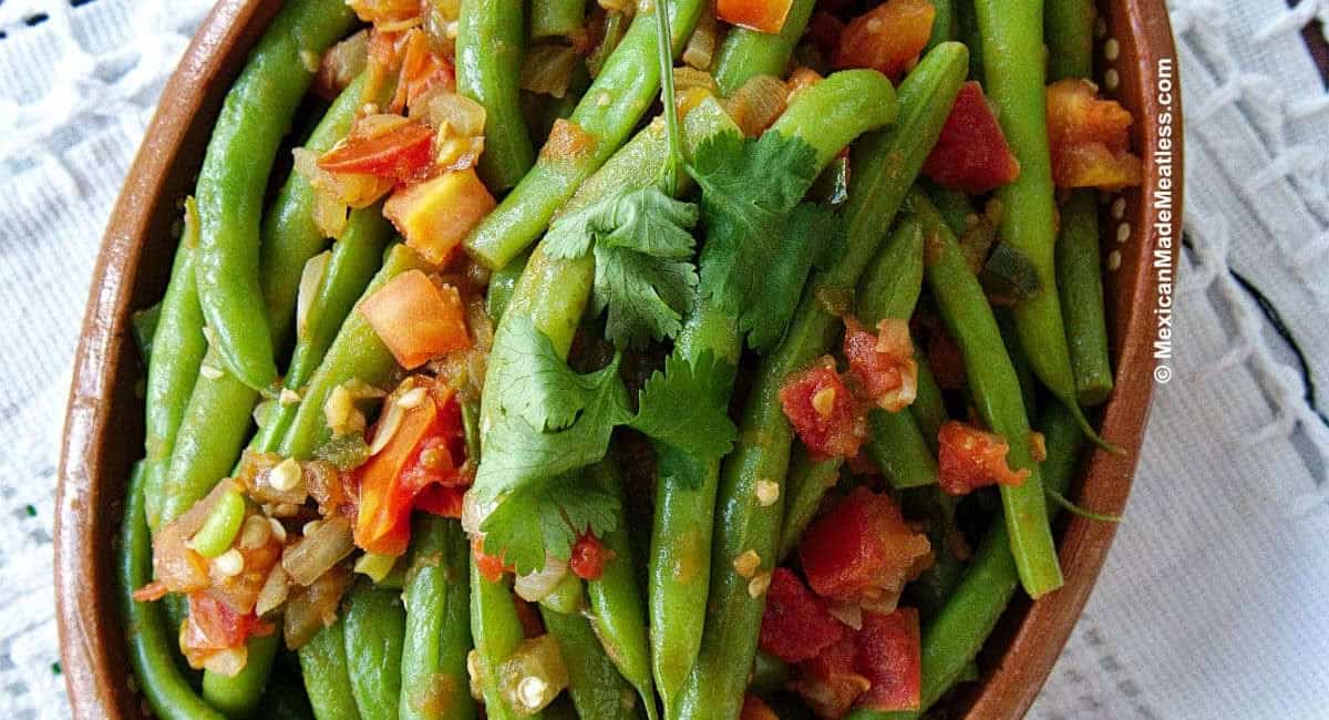 Overhead image of ejotes a la Mexicana with garnish. 