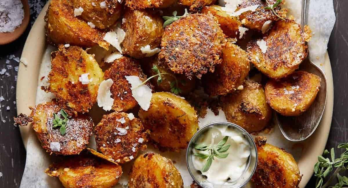Overhead image of oven roasted yukon gold potatoes with garnish. 