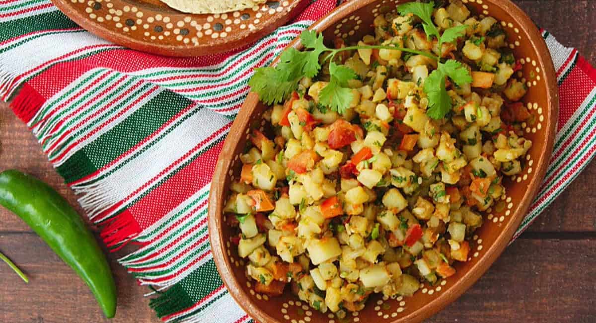 Overhead image of papas a la Mexicana with garnish. 