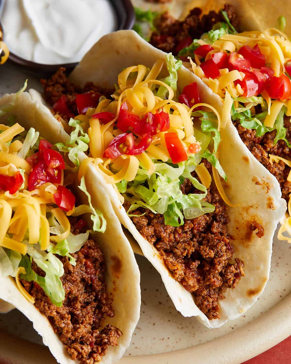 Up close image of beef soft tacos with garnish. 