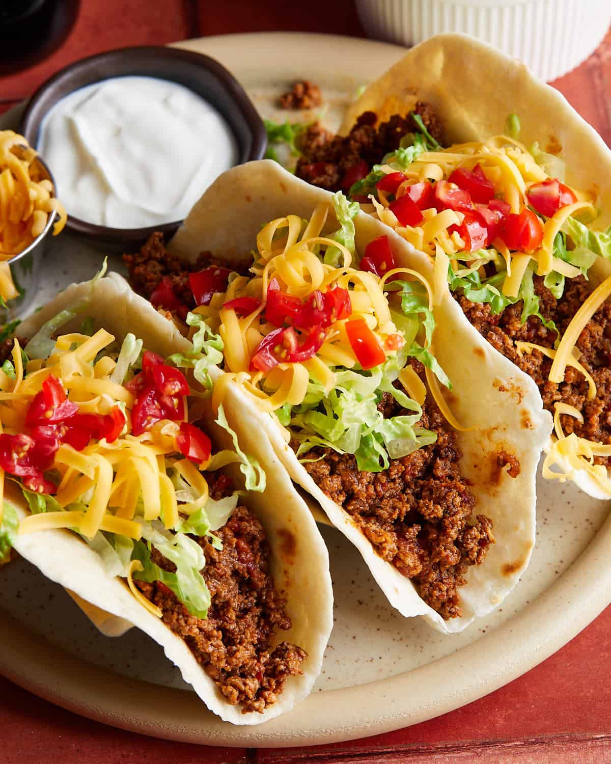 Up close image of beef soft tacos with garnish.