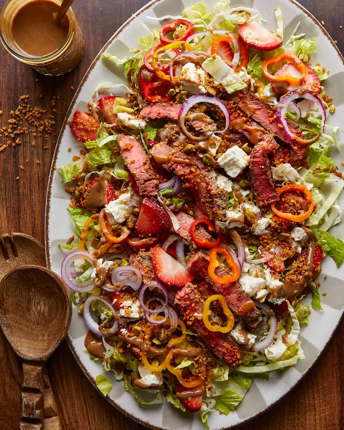 Overhead image of steak salad on white platter dish.