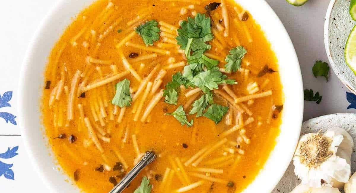Overhead image of sopa de fideo (Mexican noodle soup). 