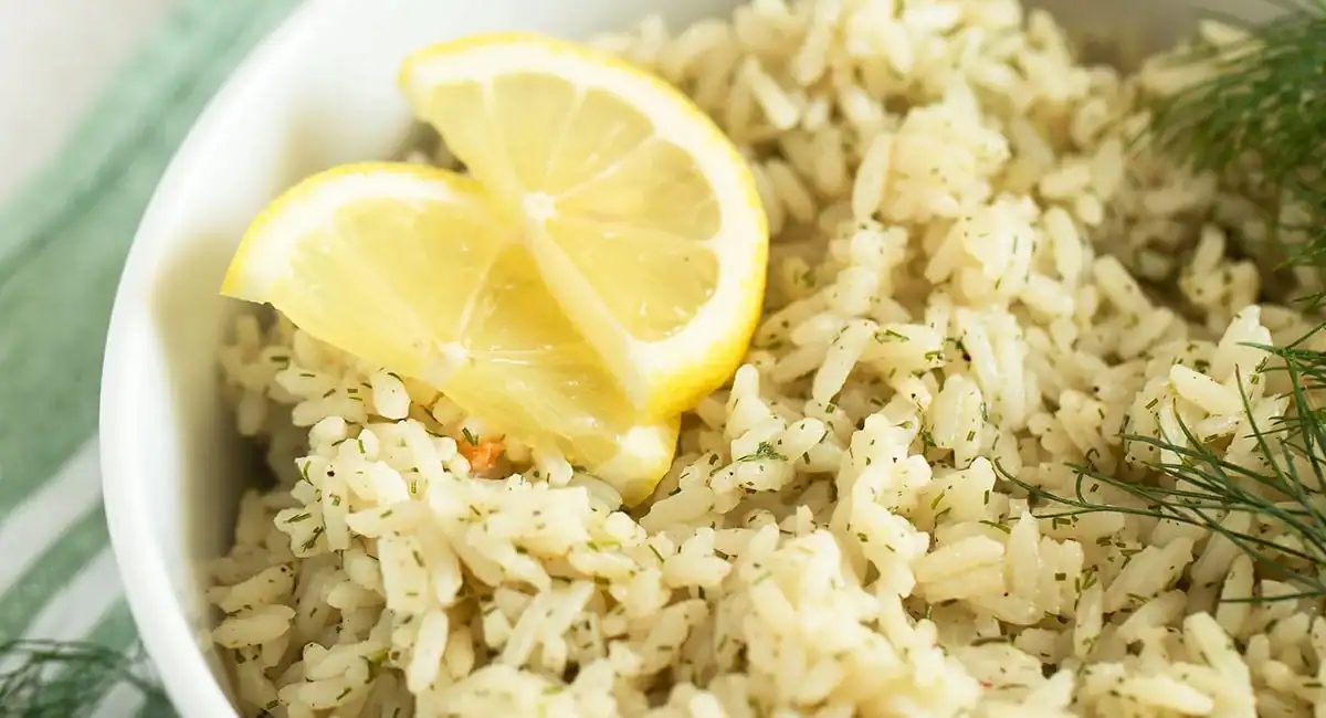 Up close image of dill lemon rice with garnish and lemon slices. 
