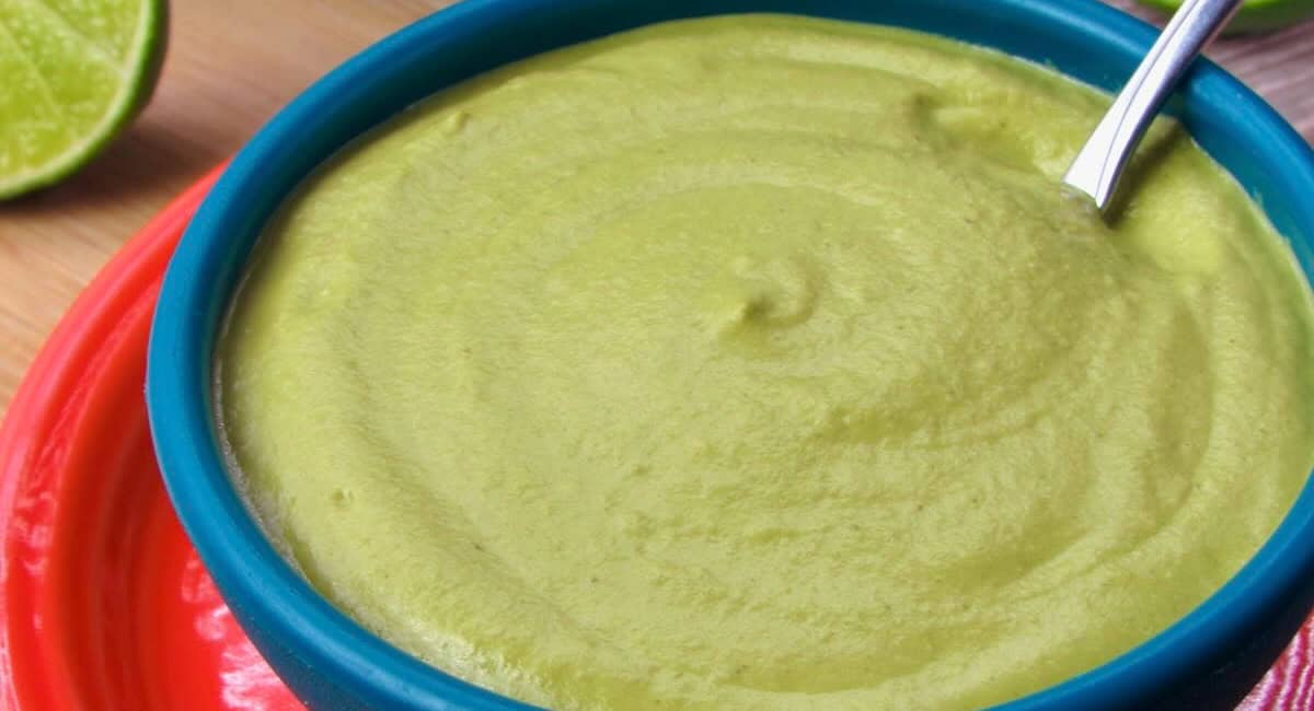 Up close image of roasted poblano sauce in blue dish. 