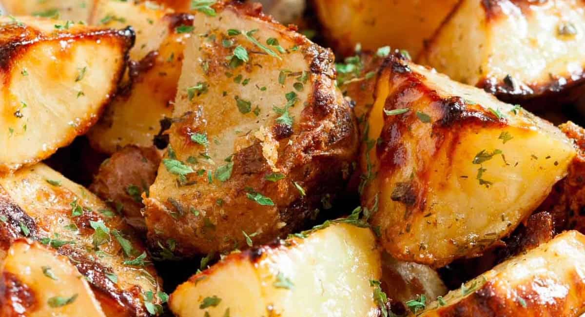Up close image of ranch roasted potatoes with garnish. 