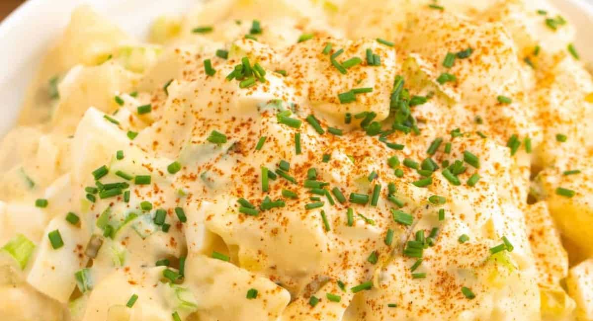 Up close image of deviled egg potato salad with garnish. 