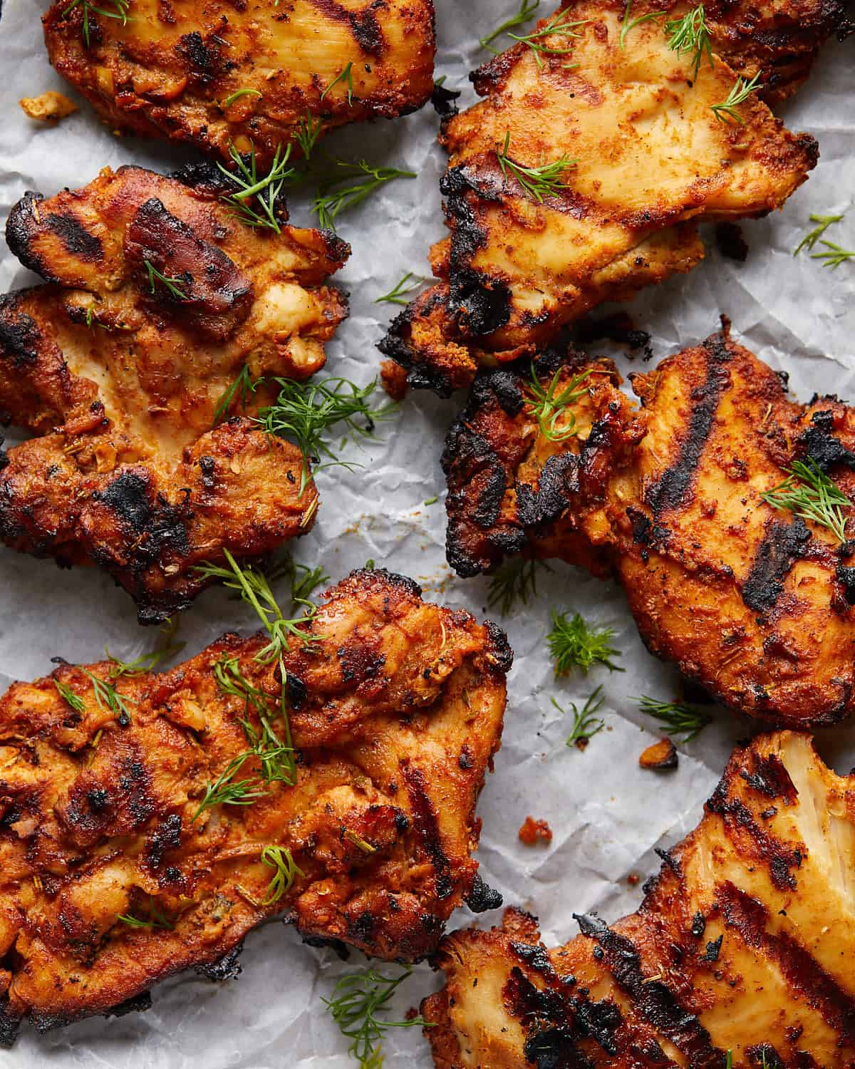Overhead up close image of grilled boneless chicken thighs. 