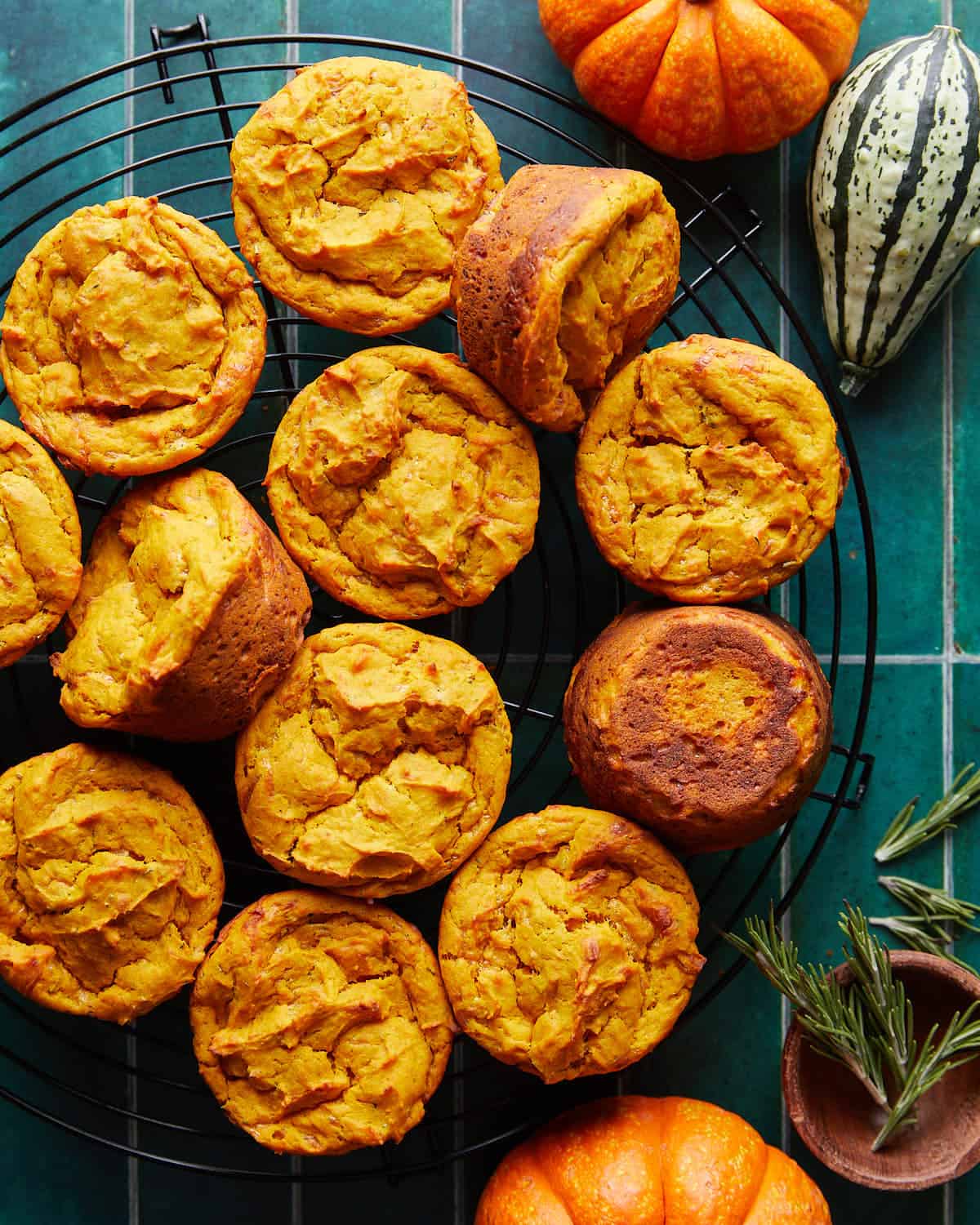 Overhead image of savory pumpkin muffins on black wire rack.
