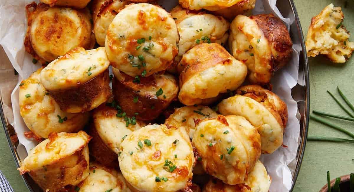 Overhead image of cheddar chive muffins with garnish. 