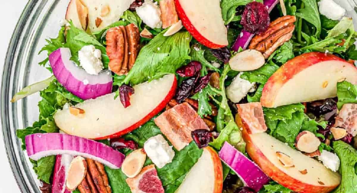 Overhead image of apple cranberry salad in clear bowl. 