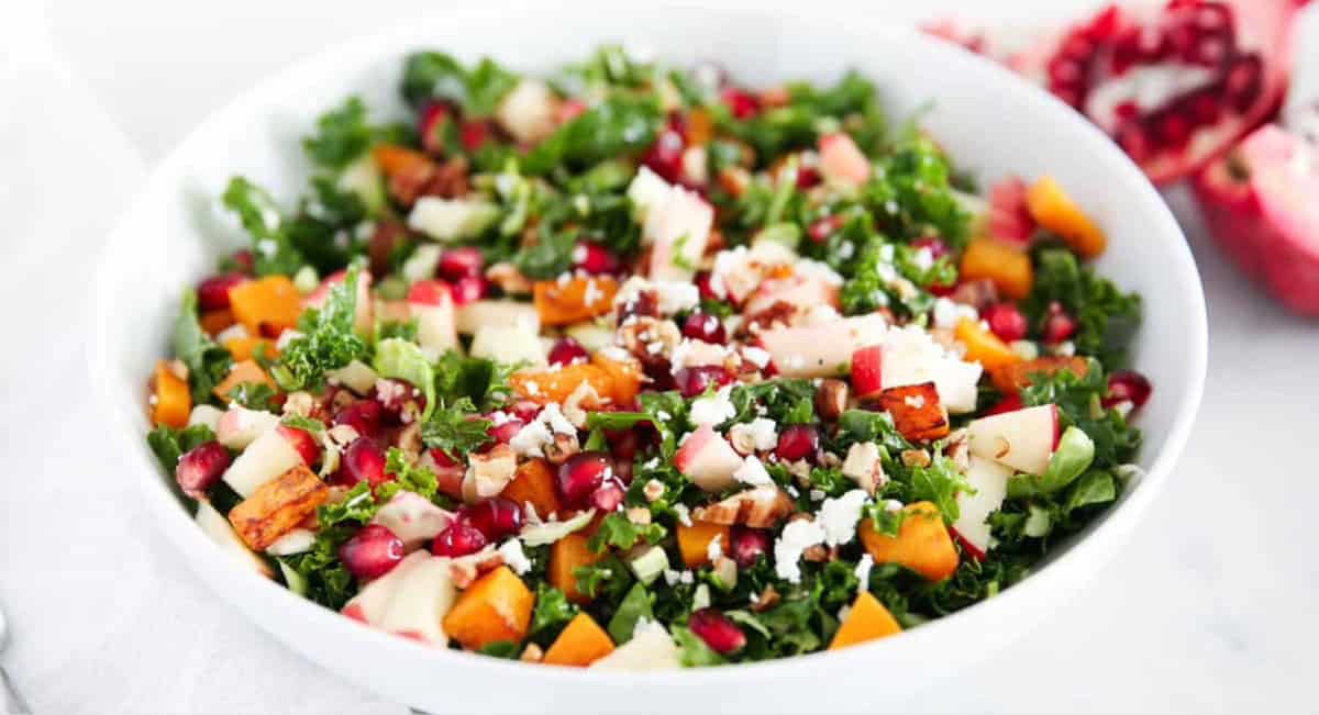 Overhead image of an easy winter salad recipe in white bowl. 