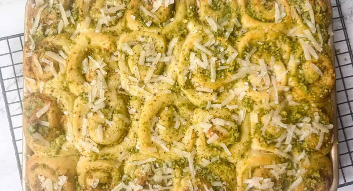 Overhead image of mini pesto rolls with garnish. 