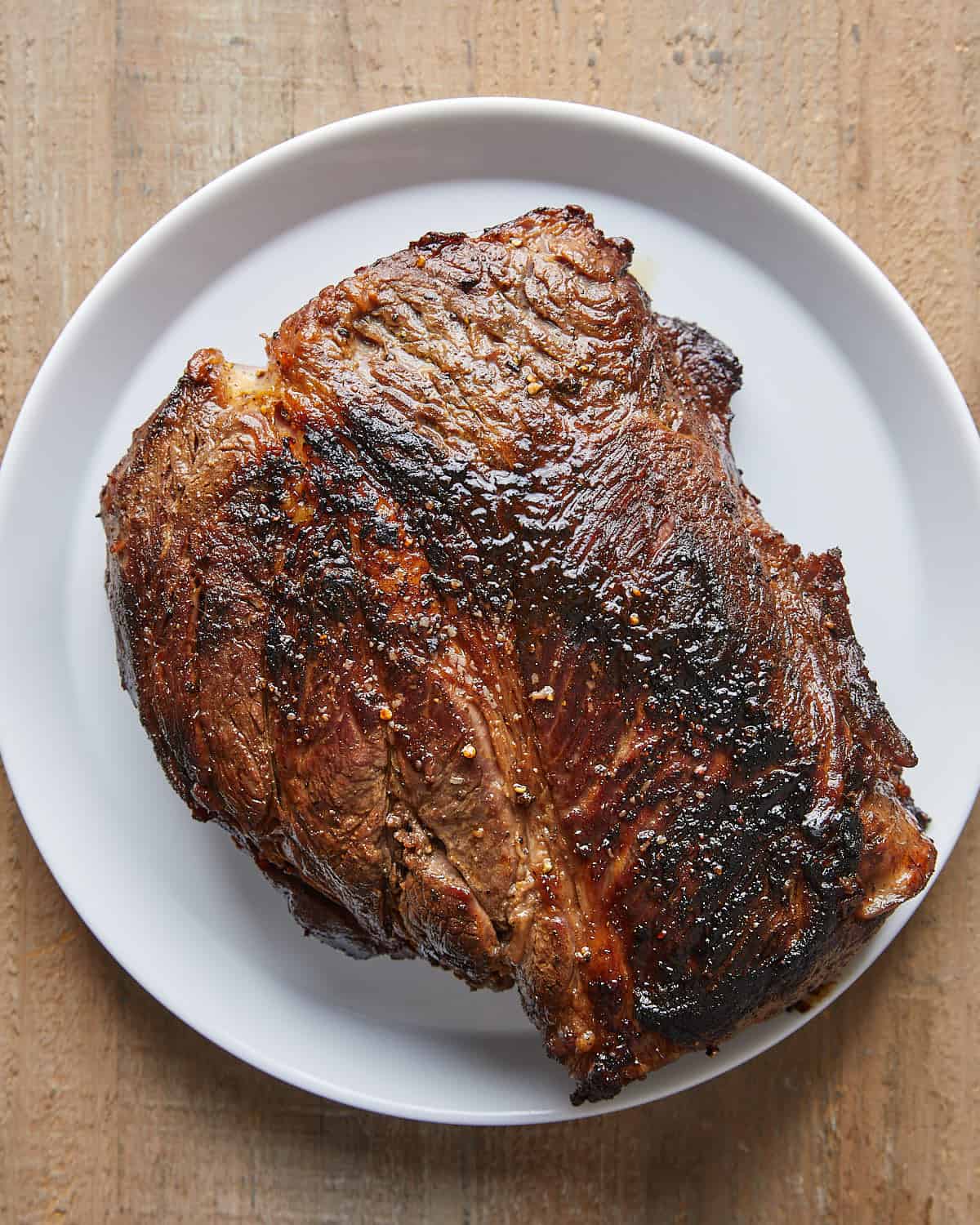 Overhead view of seared beef chuck roast prepared for Dutch Oven Pot Roast.